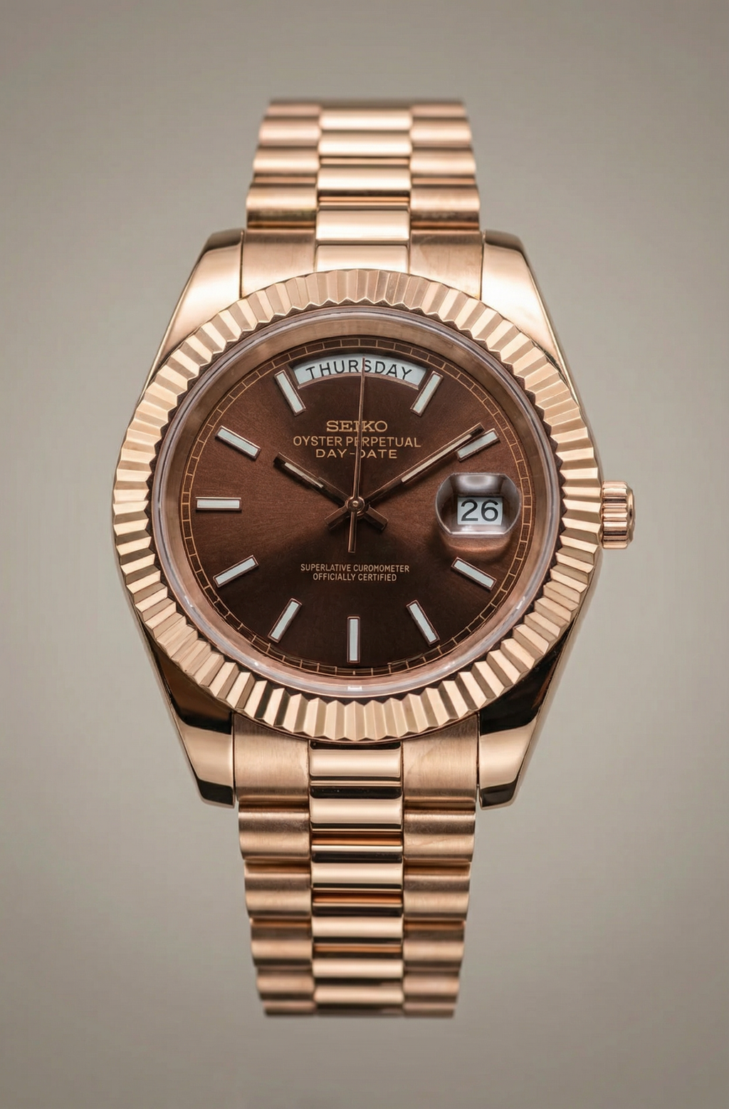 Rose gold Seiko watch with a brown dial on a gray background