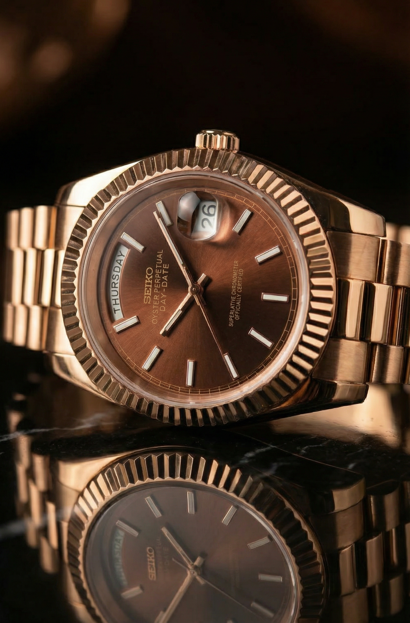 Rose gold watch with a reflective surface on a dark background